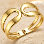Élan Sculptural Cuff Bracelet – Gold Open-Swirl Statement Bracelet